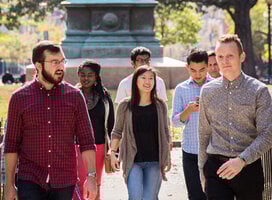 A group of students and a staff member walking outside
