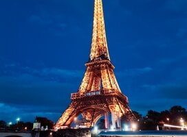 The Eiffel Tower lit up at night 
