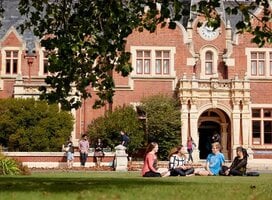 students sitting on lawn