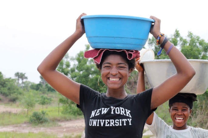 Volunteer in Ghana carrying water on head