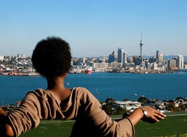 A student visiting Mount Victoria in Devonport, Auckland, looking at Auckland CBD's skyline