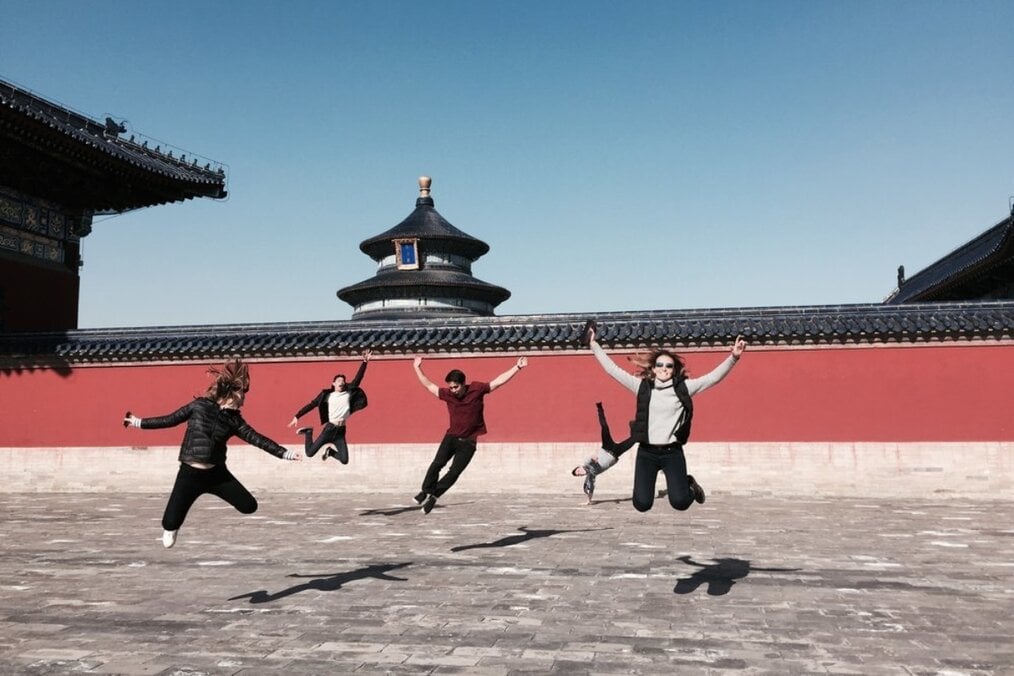 A group of friends jumping in the Temple of Heaven in Beijing