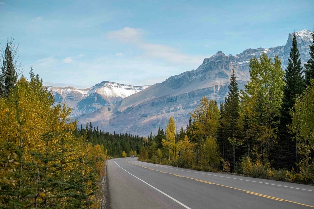 A road going through mountainous landscape 