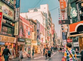 A busy street scene with colorful buildings and signs