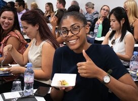 Female student of Forum-Nexus Study Abroad smiling and giving the thumbs up.