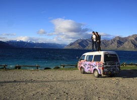 People standing on top of an adventure van in New Zealand
