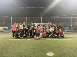 Students and local jiran posing for a photo after playing a pickup game of soccer