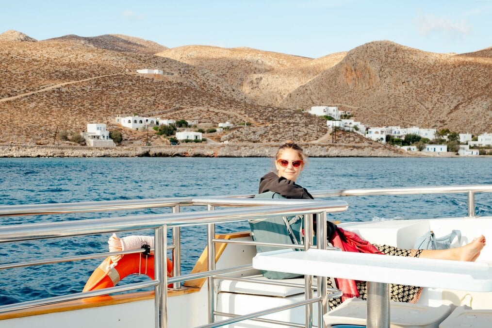 A person relaxing on a boat near the shoreline