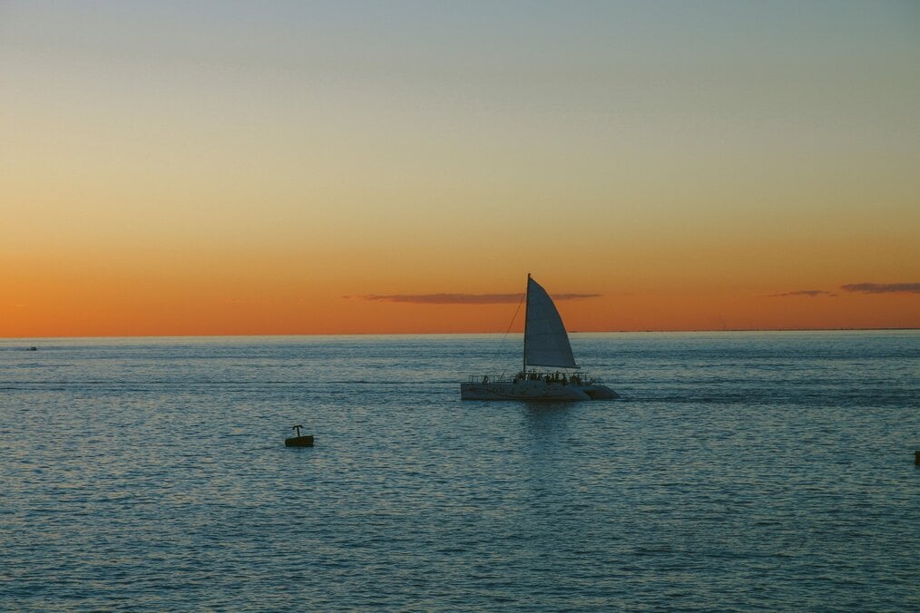 A boat sailing during a sunset