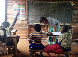 Volunteer teacher in Ugandan classroom