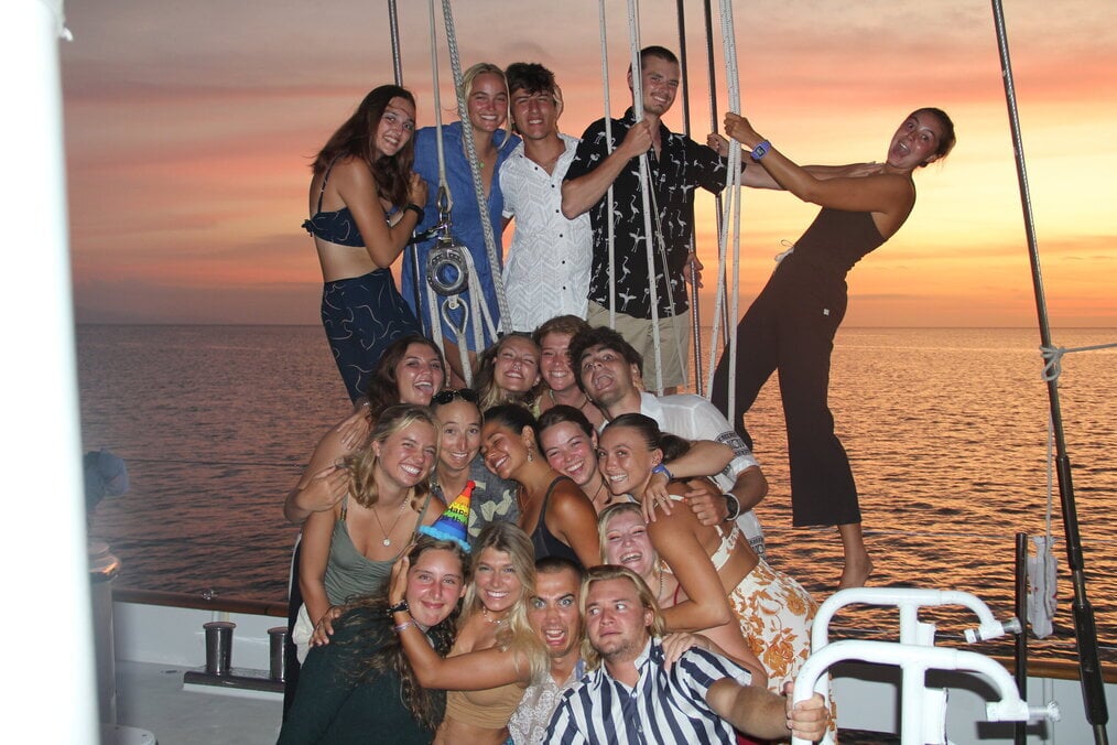 A group of friends on a boat during sunset