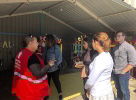 Students listening to a Save the Children worker speak 