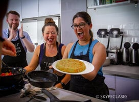 A proud student after cooking a Spanish dish