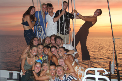 Group of students smiling on a boat